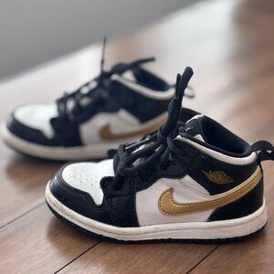 Kids Black and White Nike Air Jordan Sneakers with Gold Accents